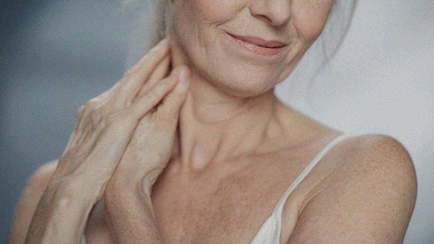 Mujer tocándose el cuello y la mandíbula