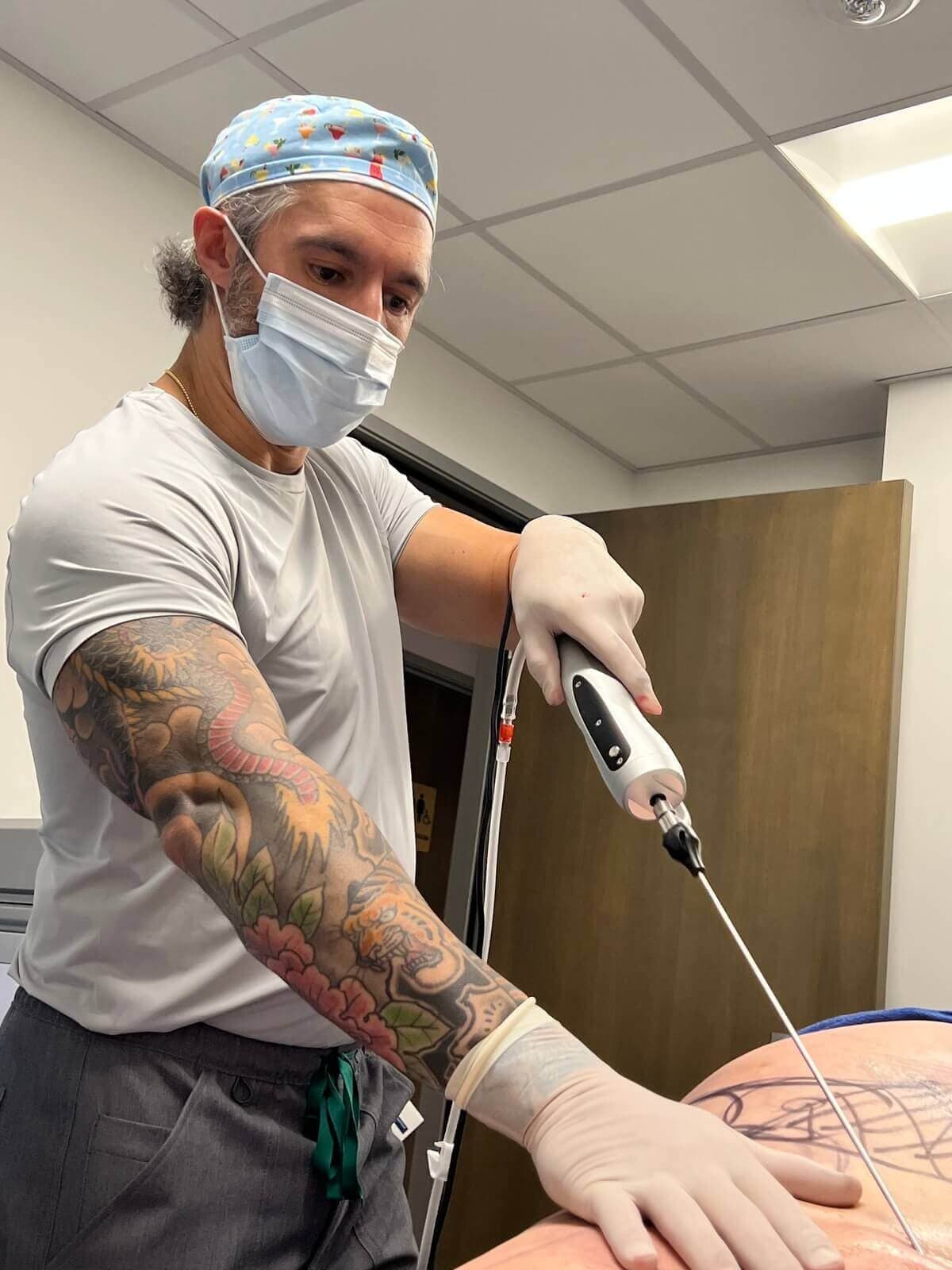 Dr. G performing liposuction in the procedure room